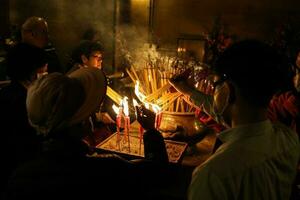 Hong Kong, Central-January 25, 2020  Devotees at Man Mo Temple for offerings and prayers for Chinese New Year.  In mist of protest and Novel coronavirus, 2019-nCoV, COVID-19. photo