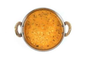 indian style dal lentil tarka spicy ghee fried dish in brass karai bowl pan on white background top view photo