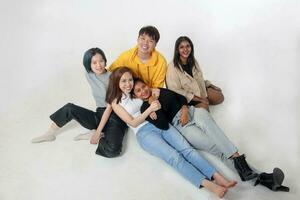 Group of young south east asian mixed race man woman chinese malay indian sit lying pose on floor enjoy relax fun talk gather pose students colleagues look at camera photo