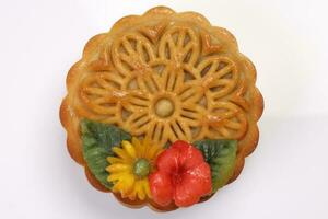 Colorful flower decorated mooncake Chinese mid autumn festival on white background photo