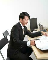 Young Asian man woman wearing business office suit chair table computer white background photo