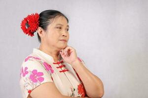 Elderly senior Asian woman posing facial expression photo