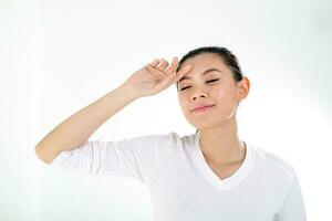 beautiful young south east Asian Chinese woman hand on forehead eye closed on white background photo