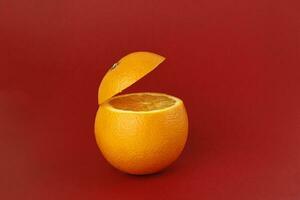 Healthy Orange Cut floating top slice juice drink idea concept on red background photo