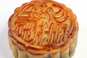 Chinese baked decorated mooncake mid autumn festival round moon cake filling gift wish offering on white background photo