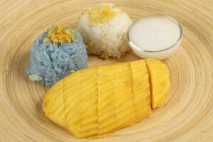 Mango butterfly pea blue white sticky rice coconut milk cream photo