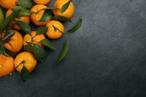 mandarin orange green leaf wood crate box top view copy text space frame on black slate background photo