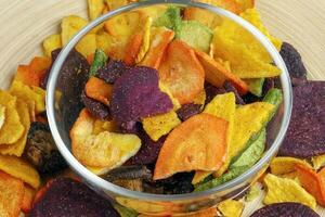 Healthy vegetable chips yellow sweet potato purple sweet potato carrot green radish green beans and shiitake mushrooms photo