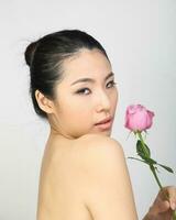 Young beautiful Southeast Asian woman beauty fashion makeup light grey white background photo