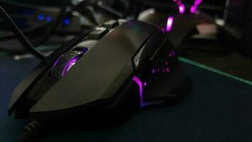 a black gaming mouse with twinkling lights. Special gaming mice have special buttons to make it easier when playing games. video