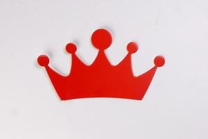 Red crown shape paper die cut selfie portrait party fun paper prop sticker stick on white background photo