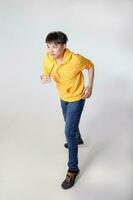 Young good looking Asian chinese malay man pose face body expression mode emotion on white background run move photo