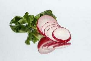 Small red radish on white reflection ackground photo