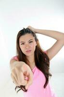 beautiful young south east Asian Chinese woman messy bad hair angry upset point at camera photo