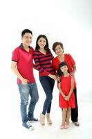 Southeast Asian multigeneration family parents daughter grandmother father mother child pose happy sit stand photo