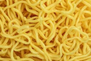 Fresh yellow egg noodle on whit background photo