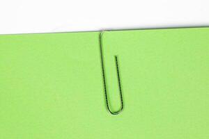 Paper clip holding on blank colour paper text copy space note photo