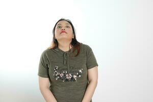 Young plus size south east asian woman pose face expression emotion on white background think pray look up photo
