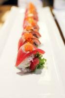 Tuna sushi with salmon row on white plate photo