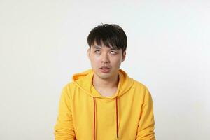 Young good looking Asian chinese malay man pose face body expression mode emotion on white background dont care funny ignore look photo