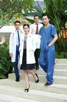 South East Asian young Malay Chinese man woman medical doctor stethoscope apron group stand pose confident photo