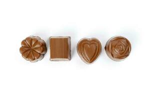 Chocolate truffle hart square cube rose flower shape on white background photo