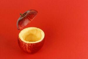 Healthy Red Cut Apple floating top slice juice drink idea concept on red background photo