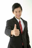 South East Asian young Chinese man wearing formal business office ware on white thumbs up photo