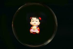 Chinese doll through glass spear photo