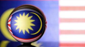 Malaysian flag refraction through glass crystal ball country independence patriot concept photo