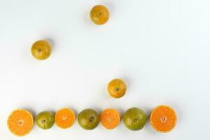 small yellow green mandarin orange whole slice on white background copy space for text frame border photo
