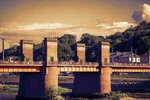 Bridge over river over the Nemunas river in Kaunas, Lithuania in sepia tones photo