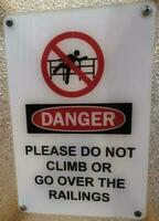 please do not climb or go over the railings sign board photo