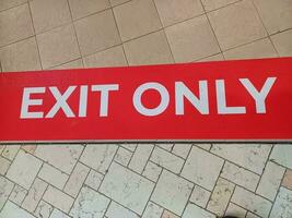 Vintage exit sign ,red and white exit sign,exit only sign on floor photo