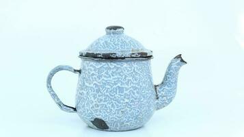 vintage enamel teapot isolated on white background.in Indonesia it is called a Eko blirik photo