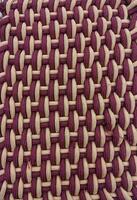 Beautiful maroon thread floral embroidery work,knitted fabric closeup,background texture photo