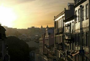 Bright sunset in Lisbon, Portugal, illuminating the buildings photo