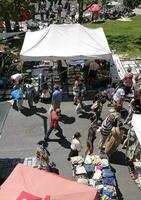 13 May 2023, Lisbon, Portugal - People examining the goods on display at the famous Feira da Ladra - Flea Market - in Lisbon, Portugal. photo