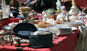 13 May 2023, Lisbon, Portugal - People examining the goods on display at the famous Feira da Ladra - Flea Market - in Lisbon, Portugal. photo