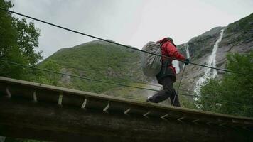 Backpacker Tourist on the Wooden Trail Bridge in the Norway video