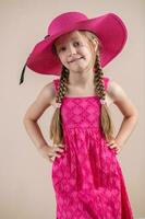 Little girl with pink dress and hat photo