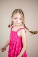 Little girl with pigtails and pink dress photo