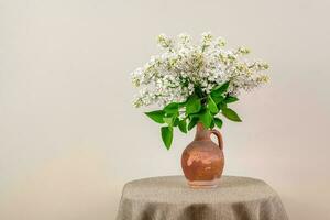 White Lilacs in Earthenware Jug photo