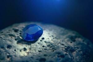 Blue Sapphire Gemstone on Natural Stone photo