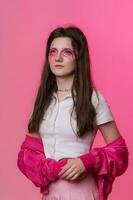 Portrait of 22-year-old female with pink make-up, dressed in pink jacket, skirt and white t-shirt photo