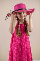 Little girl with pink dress and hat photo