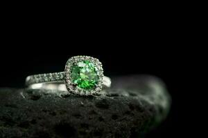 Emerald Ring on Black Natural Stone photo