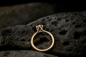 Gold Solitaire Diamond Ring on Black Stone photo