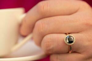 Black Diamond Ring on The Hand of a Woman photo