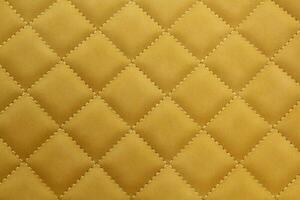 Close-up texture of beige stitched threads leather with seam background. Rhombus pattern for interior car, sofa, wall covering, headboard. Natural material on furniture backdrop. Classic design photo